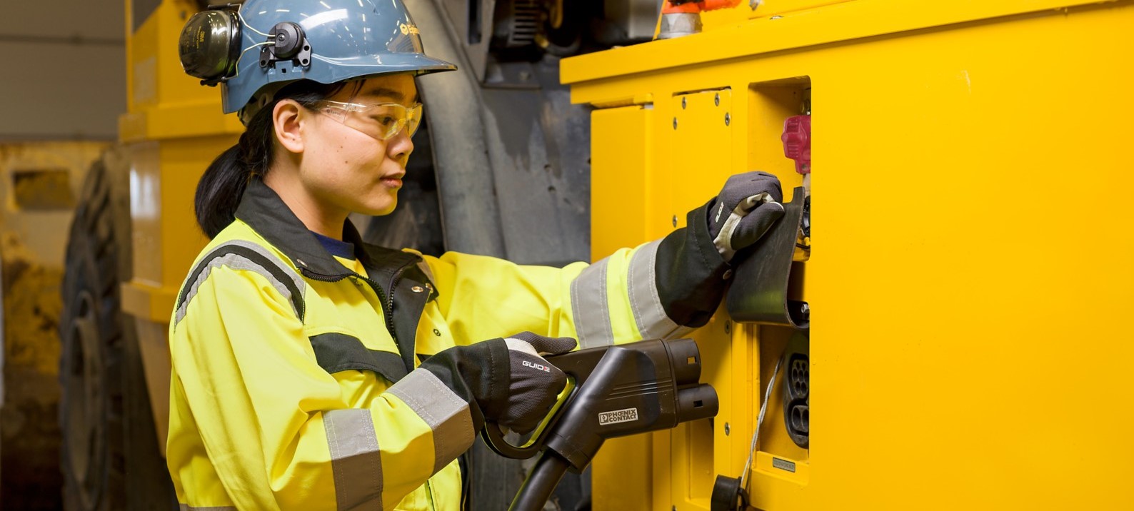 Person charging elecric mining equipment