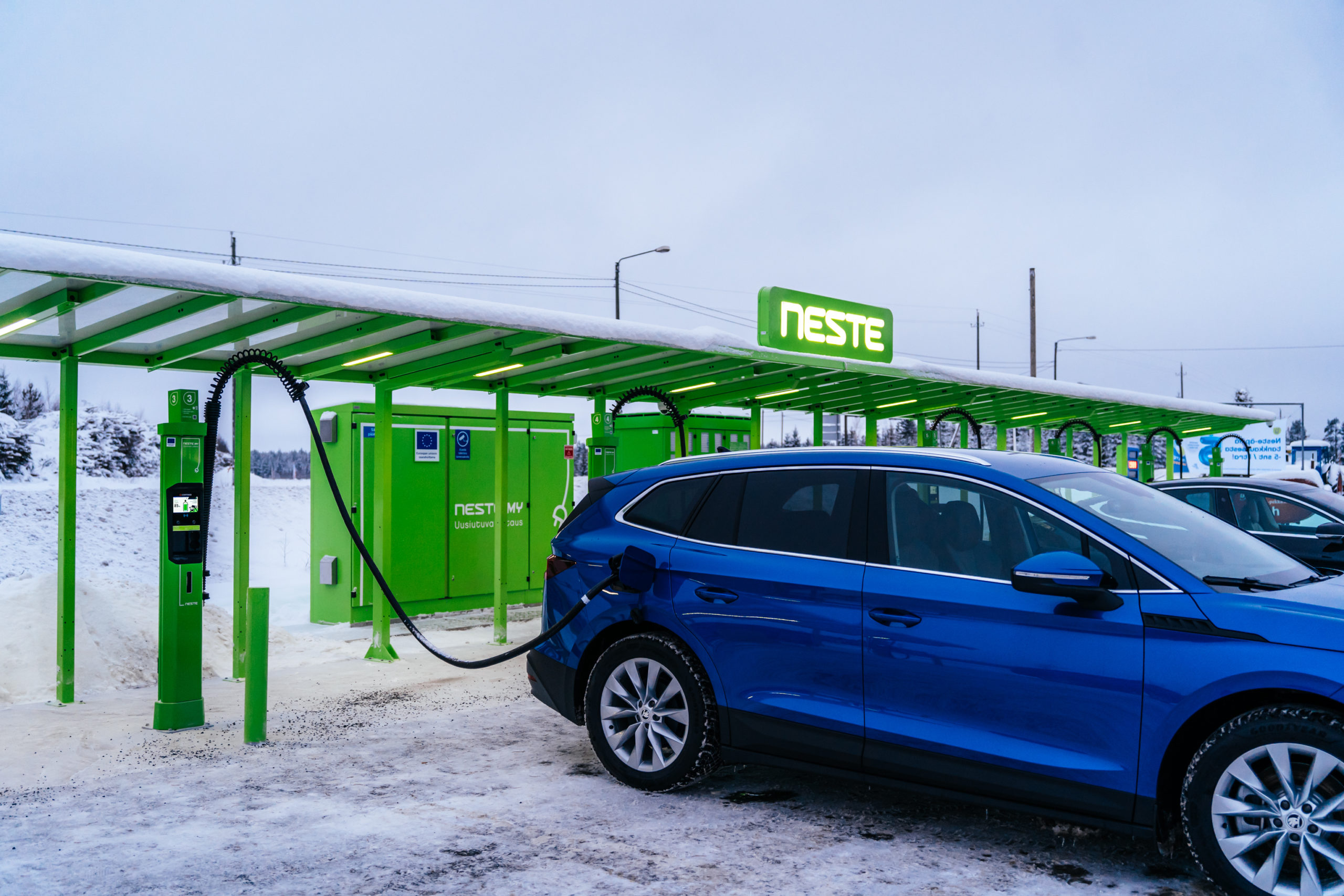 Car charging at EV charging station in finland