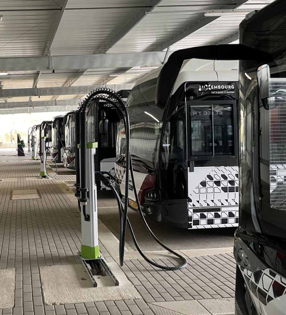 A fleet of modern trams recharging at a dedicated electric charging station, illustrating the integration of eco-friendly public transport solutions in urban settings.